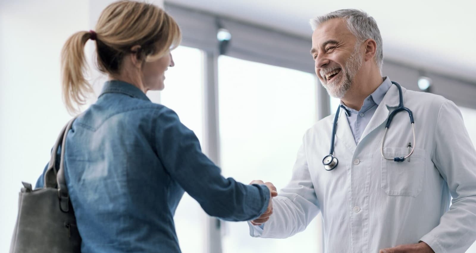 A patient greeting her doctor at a medical office appointment