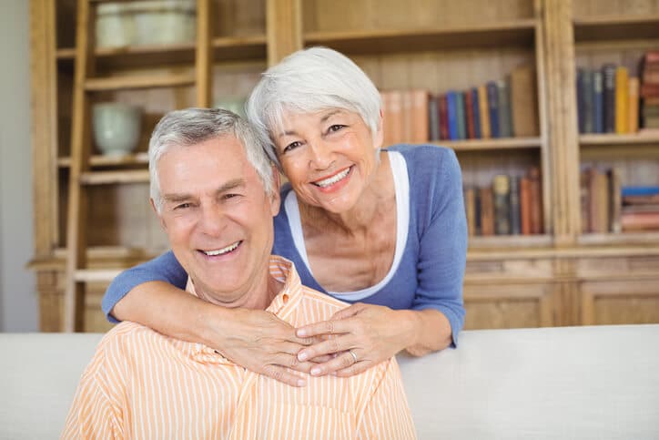 Older man and woman embracing representing retirement planning for those already retired. | Peterson Wealth Advisors